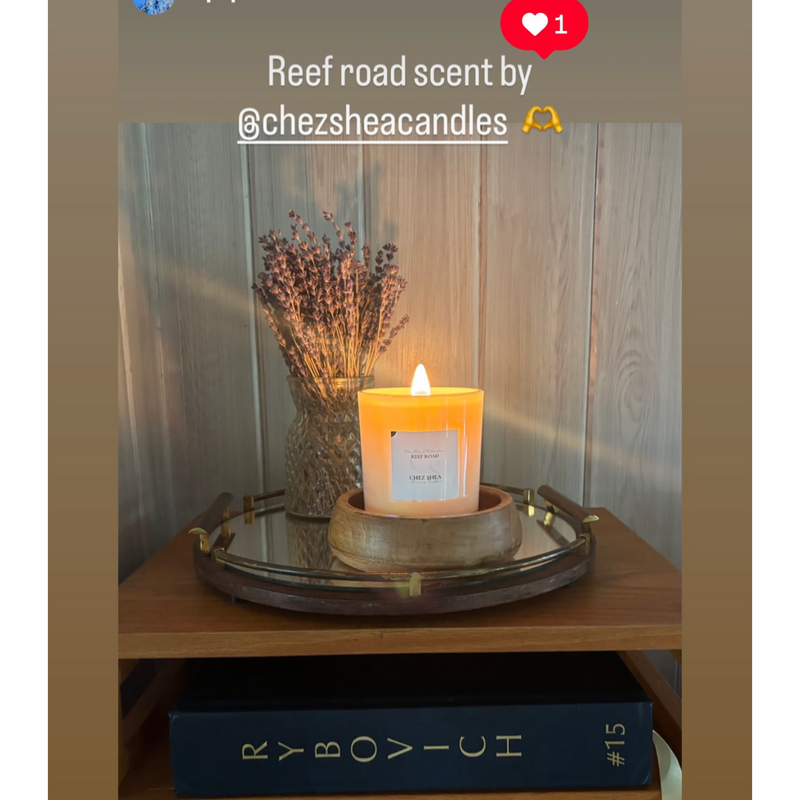 Candle with lavender in a glass jar on a wooden surface, with a smartphone interface overlay.